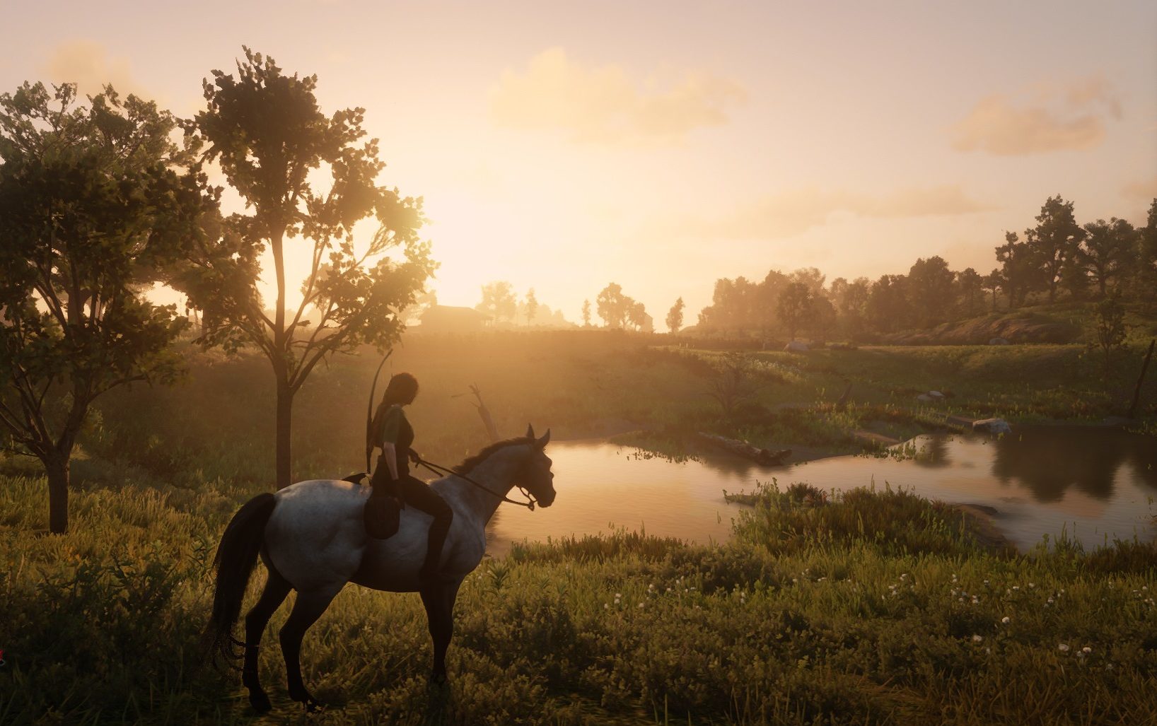 Renate sitting on horseback with her bow on her back. The sun is setting in the background over a small pond and a few trees.