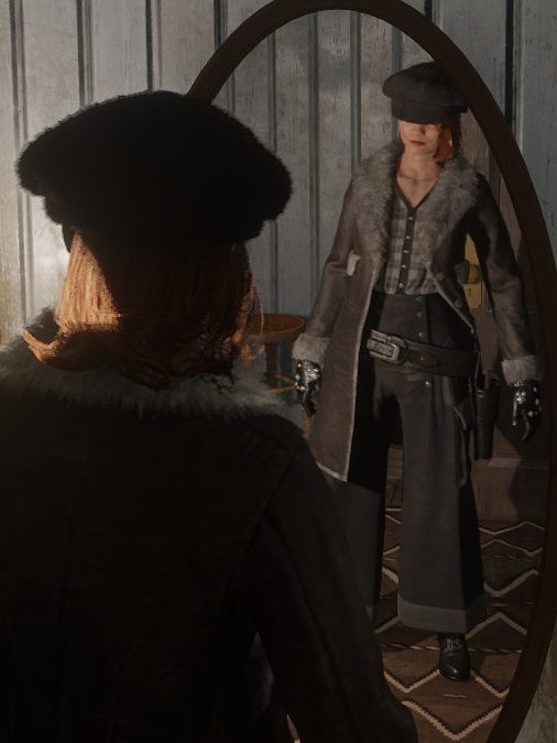 Leona with her back to us, and her reflection in a full-length mirror, wearing monochrome and a long jacket. Her face is partially obscured by a black, furry hat.